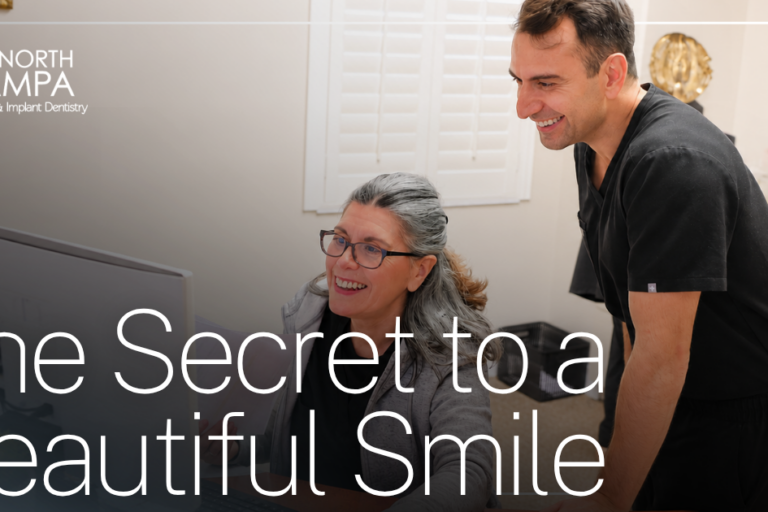 doctor and assistant smiling looking at computer
