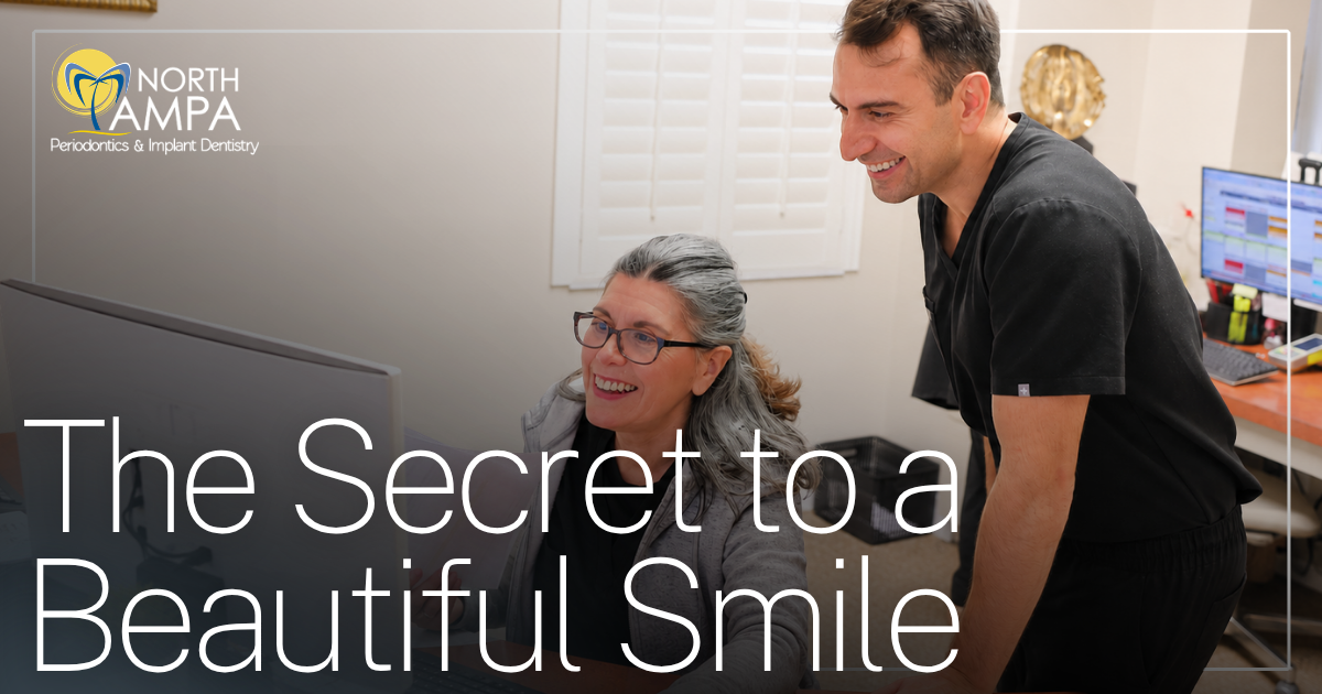 The Secret to a Beautiful Smile doctor and assistant smiling looking at computer